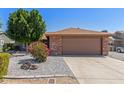 Charming single-story home featuring a low-maintenance desert landscape and a two-car garage at 6413 W Monte Cristo Ave, Glendale, AZ 85306