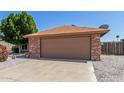 Two car garage featuring brick accents and an extra long driveway at 6413 W Monte Cristo Ave, Glendale, AZ 85306