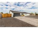 Modern home featuring a gray garage door, light stucco exterior, and well-maintained landscaping at 6908 W Wanda Lynn Ln, Peoria, AZ 85382
