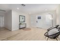 Bright, open living room with neutral walls, light wood-look floors, and contemporary decor at 6908 W Wanda Lynn Ln, Peoria, AZ 85382