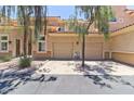 Condo with a two-car garage, a stucco exterior, with a terracotta roof at 8245 E Bell Rd # 128, Scottsdale, AZ 85260