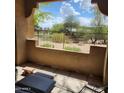 Charming patio with scenic views of lush landscape and blue skies, perfect for outdoor relaxation and entertaining at 8245 E Bell Rd # 128, Scottsdale, AZ 85260