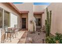 Inviting courtyard with decorative cacti and a peaceful fountain feature at 8307 S Desert Preserve Ct, Gold Canyon, AZ 85118