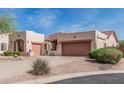 Beautiful home with desert landscaping, tile roof, and tan stucco exterior at 8307 S Desert Preserve Ct, Gold Canyon, AZ 85118