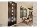 Stylish front door with glass accents, seating area, and view of interior space at 8340 E Mcdonald Dr # 1016, Scottsdale, AZ 85250