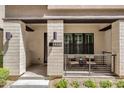 Inviting front porch with seating area, stylish light fixtures, and unit number at 8340 E Mcdonald Dr # 1016, Scottsdale, AZ 85250