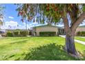 Inviting home features a vibrant green lawn and well-maintained landscaping, offering great curb appeal at 10619 W Highwood Ln, Sun City, AZ 85373