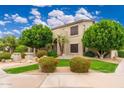 Beautifully landscaped front yard with vibrant greenery and a well-maintained lawn at 1074 E Carla Vista Ct, Gilbert, AZ 85295