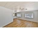 Spacious living room features new floors, lots of windows, and ceiling fan at 110 S 72Nd Way, Mesa, AZ 85208
