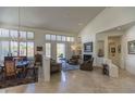 Spacious living room featuring neutral decor, plantation shutters, fireplace, and seamless access to the outdoors at 11736 E Del Timbre Dr, Scottsdale, AZ 85259