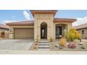 Charming home featuring desert landscaping, a barrel tile roof, and a stone entrance at 12031 S 184Th Ave, Goodyear, AZ 85338