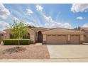 Charming single-story home with a three-car garage and well-maintained desert landscaping at 1211 W Hawken Way, Chandler, AZ 85286