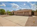 Charming single-story home with a three-car garage, wide driveway, and xeriscaping at 1211 W Hawken Way, Chandler, AZ 85286