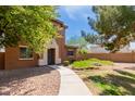 Home exterior featuring drought-tolerant landscaping, walkway, and neutral-toned stucco at 14239 W Port Royale Ln, Surprise, AZ 85379