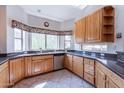 Bright kitchen featuring light wood cabinets, granite countertops, stainless steel appliances, and a large bay window at 1539 E Brenda Dr, Casa Grande, AZ 85122