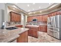 Modern kitchen features granite countertops, stainless steel appliances, an island and wood cabinets at 15413 S 31St Pl, Phoenix, AZ 85048
