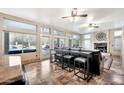 An open living room offers natural light with a wall of windows, stone floors, and leather seating at 15413 S 31St Pl, Phoenix, AZ 85048