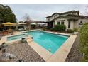 Inviting backyard pool and spa, surrounded by a lounge area perfect for outdoor relaxation and entertaining at 15418 W Surrey Dr, Surprise, AZ 85379