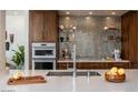 Modern kitchen with sleek countertops, stainless steel appliances, and stylish backsplash at 1621 E Maryland Ave, Phoenix, AZ 85016