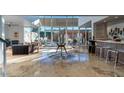 Spacious open-concept living area with floor-to-ceiling windows and modern furnishings at 1621 E Maryland Ave, Phoenix, AZ 85016