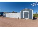 This outbuilding has a secure fenced-in area, offering secure storage or hobby space at 16643 W Quail Run Rd, Surprise, AZ 85378