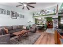 Inviting living room with wood flooring, a ceiling fan, and open dining area with a decorative wall at 16739 E El Lago Blvd # 202, Fountain Hills, AZ 85268