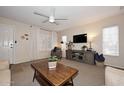Bright living room with a contemporary ceiling fan, large windows and nice furnishings at 17606 N 17Th Pl # 1115, Phoenix, AZ 85022