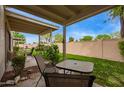 Inviting covered patio and backyard, perfect for entertaining guests or relaxing outdoors at 18725 N 92Nd Dr, Peoria, AZ 85382