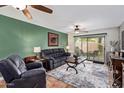 Cozy living room with comfortable seating and sliding door leading to the backyard at 18725 N 92Nd Dr, Peoria, AZ 85382