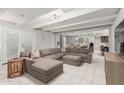 An open-concept living room featuring tile floors, and a large sectional sofa at 23405 N 84Th St, Scottsdale, AZ 85255