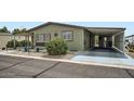 A charming single-story home showing the carport and desert-style landscaping at 2400 E Baseline Ave # 94, Apache Junction, AZ 85119