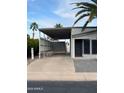 Charming home showcasing a covered carport, secure entry, and desert landscape at 2661 N Wright Way, Mesa, AZ 85215