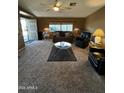 Inviting living room featuring neutral carpet, comfortable seating, and bright natural light at 2661 N Wright Way, Mesa, AZ 85215