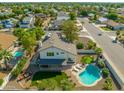 Aerial view of the backyard with a pool, putting green, patio, and surrounding neighborhood at 2818 N Yucca St, Chandler, AZ 85224