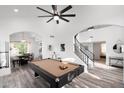 Open-concept living area featuring a pool table, spiral staircase, modern light fixture and dining space at 2818 N Yucca St, Chandler, AZ 85224