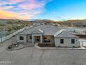 Stunning aerial view of home featuring desert landscaping, fire pit, and inviting outdoor seating area at 28204 N Royce Rd, Queen Creek, AZ 85144