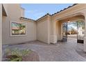 Beautiful courtyard with arched entrance, brick pavers, a small palm, and view of the street at 3557 S Halsted Ct, Chandler, AZ 85286