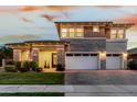 Inviting two-story home with a stone facade, manicured lawn, and a double garage at 3749 E Sagebrush St, Gilbert, AZ 85296