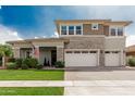 Beautiful two-story home featuring manicured lawn, stone accents, and double garage at 3749 E Sagebrush St, Gilbert, AZ 85296