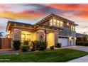 Charming two-story home with stone accents, manicured lawn, and a welcoming facade at twilight at 3749 E Sagebrush St, Gilbert, AZ 85296