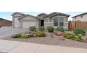 Close up of a house with a beautifully xeriscaped front yard, perfect for low-maintenance living at 40610 W Desert Fairways Dr, Maricopa, AZ 85138