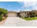 Single-Gathering home featuring a spacious driveway, two-car garage, desert landscaping and stone accents at 4313 N 161St Ave, Goodyear, AZ 85395