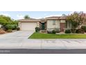Well-maintained home with a two-car garage, neutral stucco, tile roof, and charming desert landscape at 4313 N 161St Ave, Goodyear, AZ 85395