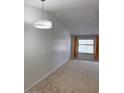 Bright living room boasting neutral carpet, vaulted ceilings, and a large window for plenty of natural light at 461 W Holmes Ave # 374, Mesa, AZ 85210