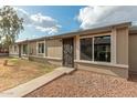 Home featuring desert landscaping, pathway to the front door, and large windows providing natural light at 6711 W Osborn Rd # 68, Phoenix, AZ 85033