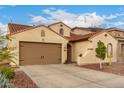 Charming single-story home featuring a tile roof, arched windows, and a two-car garage at 6904 W Ashby Dr, Peoria, AZ 85383