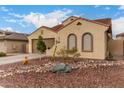 Charming single-story home featuring a tile roof, arched windows, and a low-maintenance desert landscape at 6904 W Ashby Dr, Peoria, AZ 85383