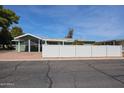 Property featuring a white fence, screened in porch and well kept low maintenance landscaping at 6960 W Peoria Ave # 237, Peoria, AZ 85345