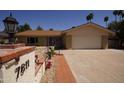 Attractive single-story home with a well-maintained lawn and mature palm trees, offering a welcoming curb appeal at 7811 N 46Th Ave, Glendale, AZ 85301