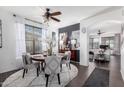 Cozy dining area featuring a round table, stylish chairs, and elegant decor with easy access to the living room at 8341 W Palo Verde Ave, Peoria, AZ 85345